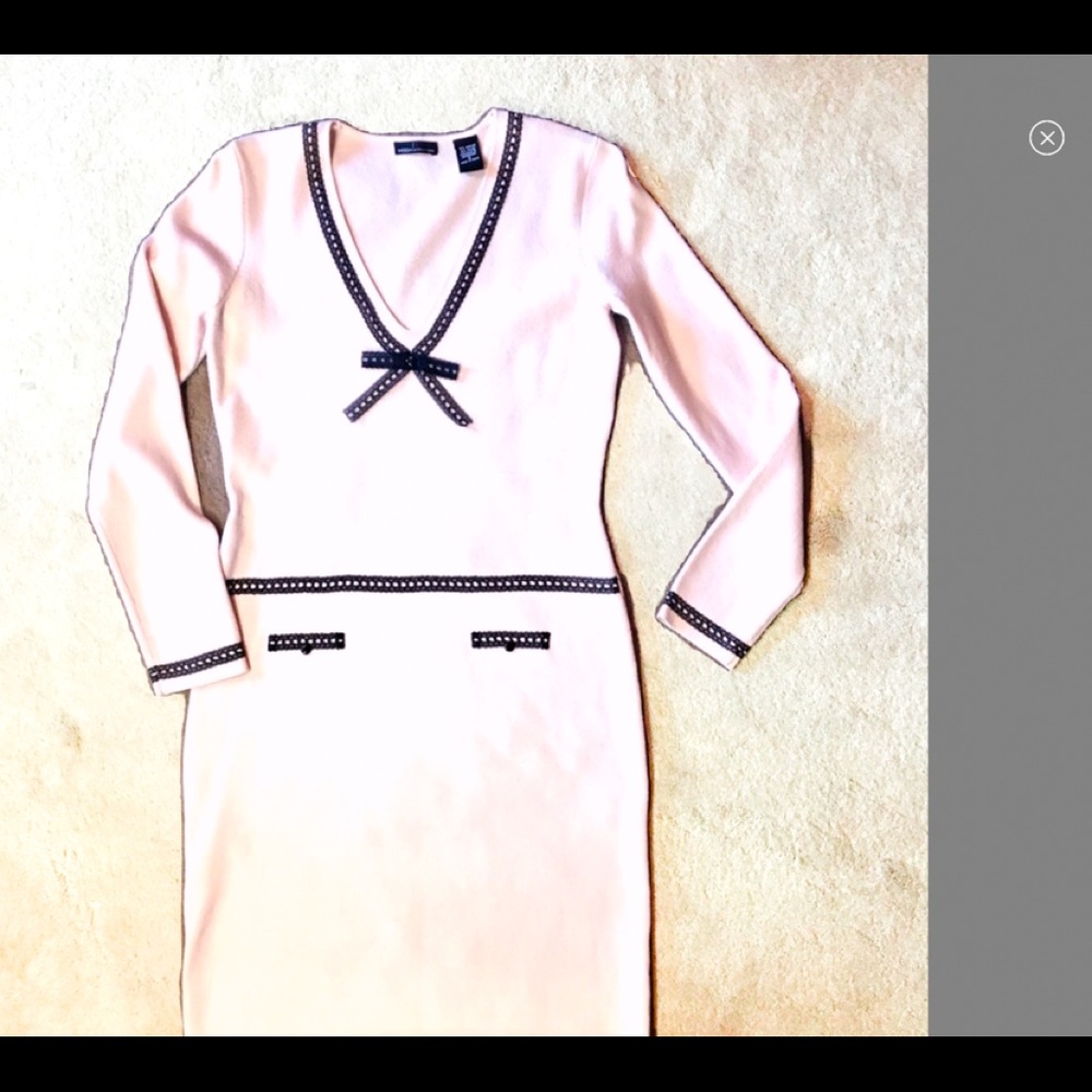 Pale pink sweater dress with black trim.